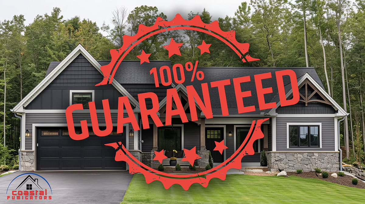 A photo of a dark gray frame house with a stamped red logo over it that says 100% Guaranteed.